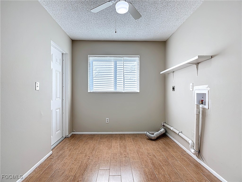 5946 Stringfellow Road St. James City, FL 33956 - Photo 37 of 50 an empty room with wooden floor and windows