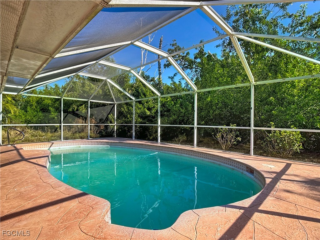 5946 Stringfellow Road St. James City, FL 33956 - Photo 43 of 50 a view of a backyard with table and chairs