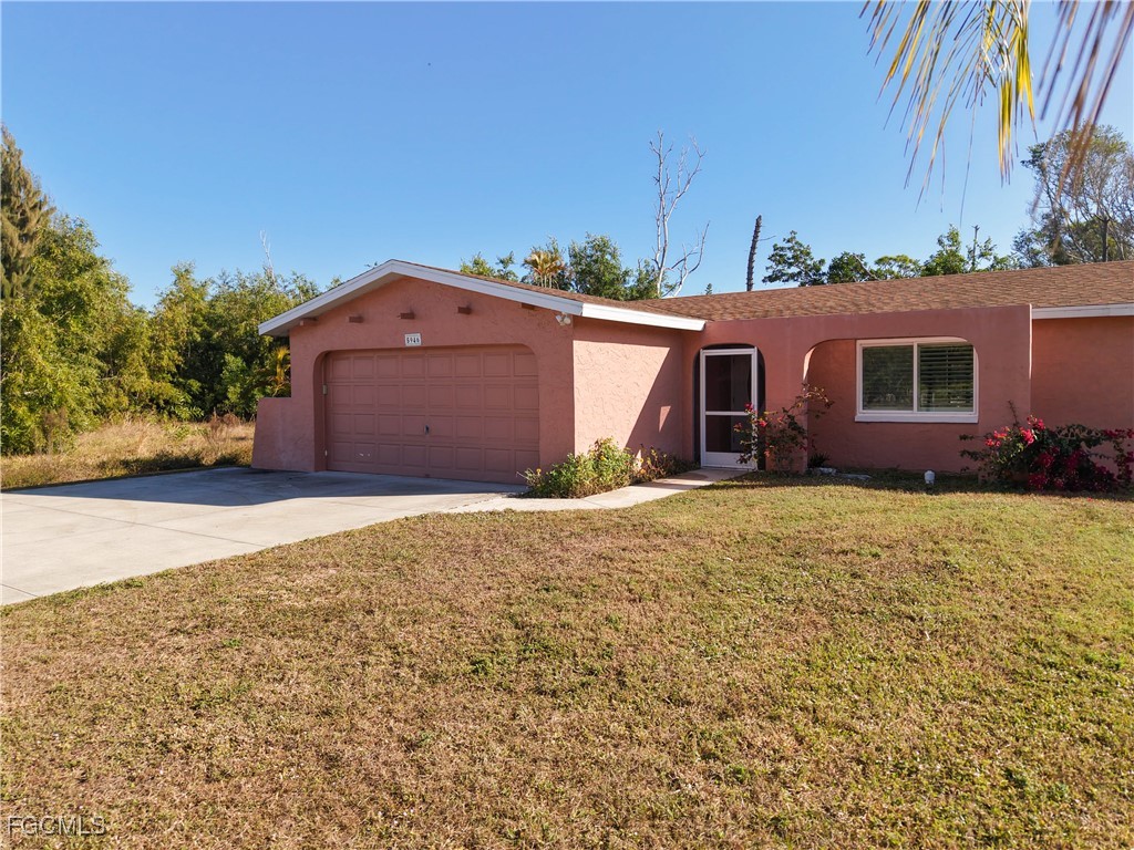 5946 Stringfellow Road St. James City, FL 33956 - Photo 6 of 50 a front view of a house with a yard