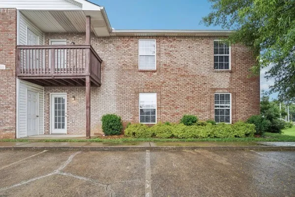 front view of a brick house with a street