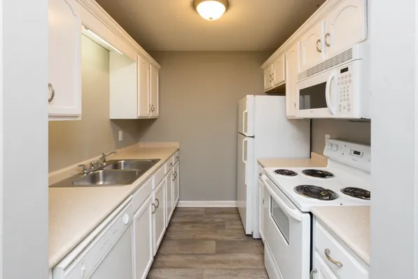 a kitchen with stainless steel appliances a sink a stove and a refrigerator