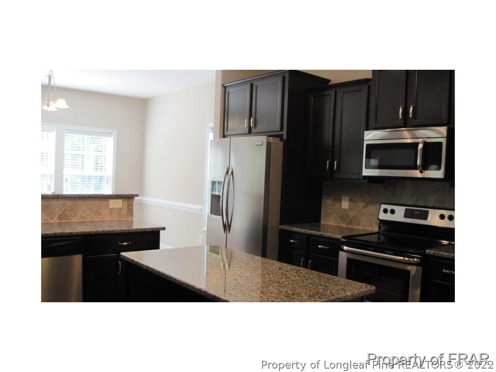 775 Sun Road Aberdeen, NC 28315 - Photo 8 of 17 a kitchen with a sink stainless steel appliances and cabinets