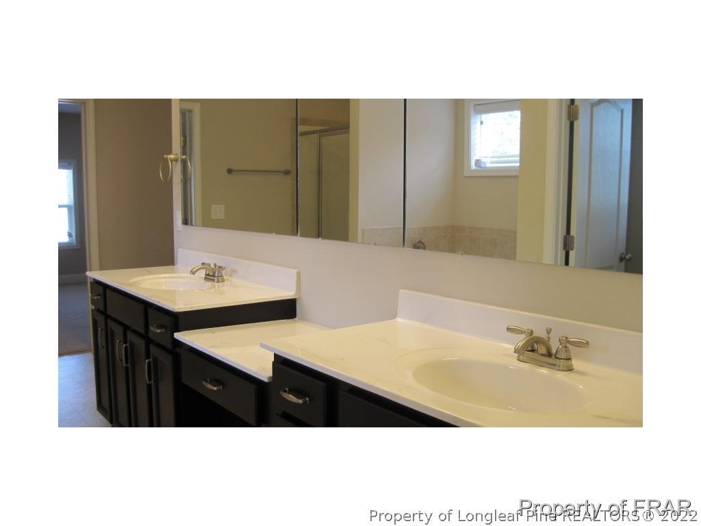 775 Sun Road Aberdeen, NC 28315 - Photo 10 of 17 a bathroom with a sink vanity and a mirror