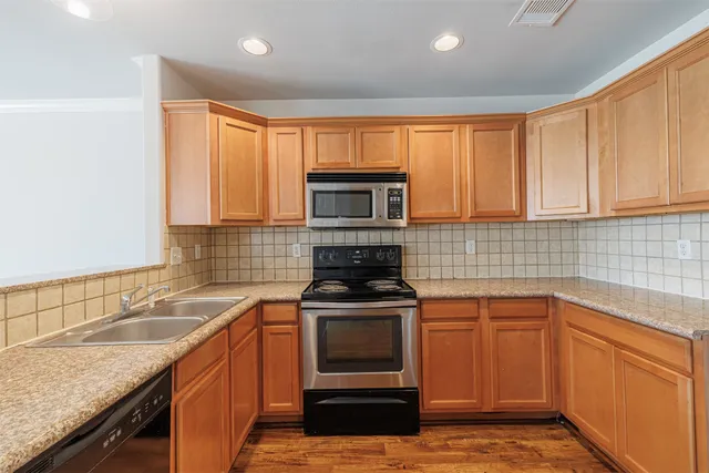 a kitchen with a sink stove and microwave