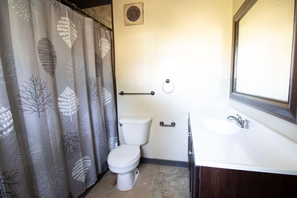 2609 County Road 7110 Lubbock, TX 79404 - Photo 21 of 29 a white toilet sitting next to a bathroom sink