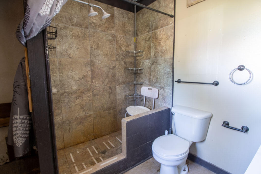 2609 County Road 7110 Lubbock, TX 79404 - Photo 22 of 29 a white toilet sitting next to a bathroom sink and a shower