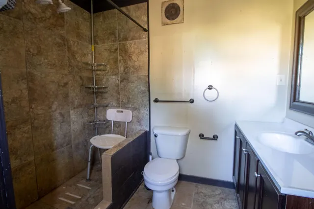 a bathroom with a toilet sink and shower