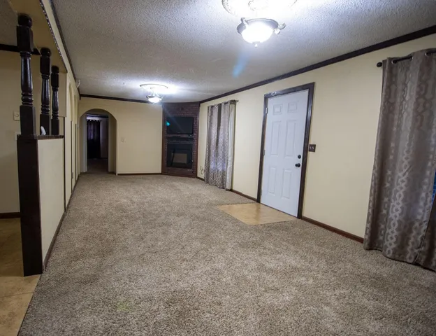 an empty room with closet and windows