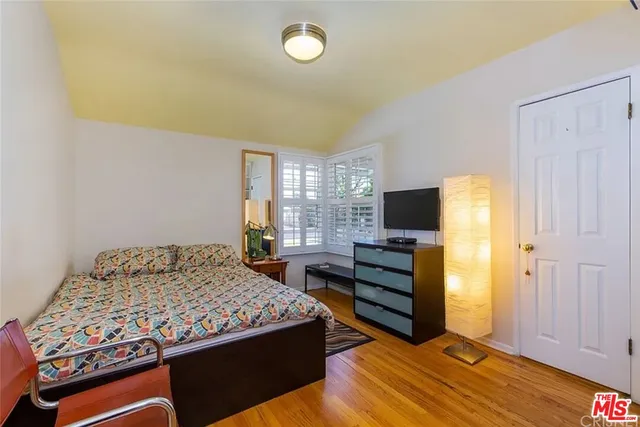 a bedroom with a bed and flat screen tv