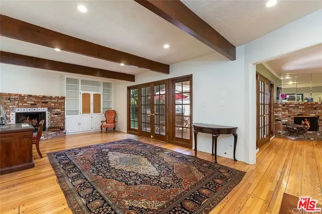 a living room with furniture rug and wooden floor