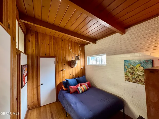 a bedroom with furniture and a wooden floor