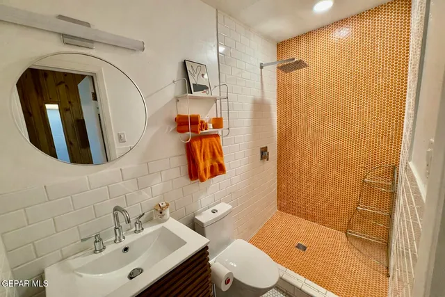 a bathroom with a sink toilet and shower