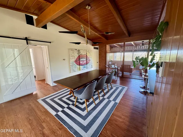 a living room with furniture rug and wooden floor