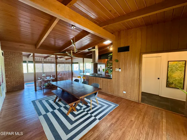 a living room with furniture a wooden floor and next to a window