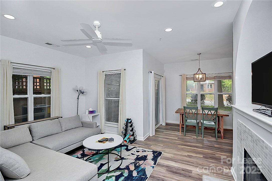 2625 East 5th Street, Unit A Charlotte, NC 28204 - Photo 16 of 24 a living room with furniture a flat screen tv and a large window