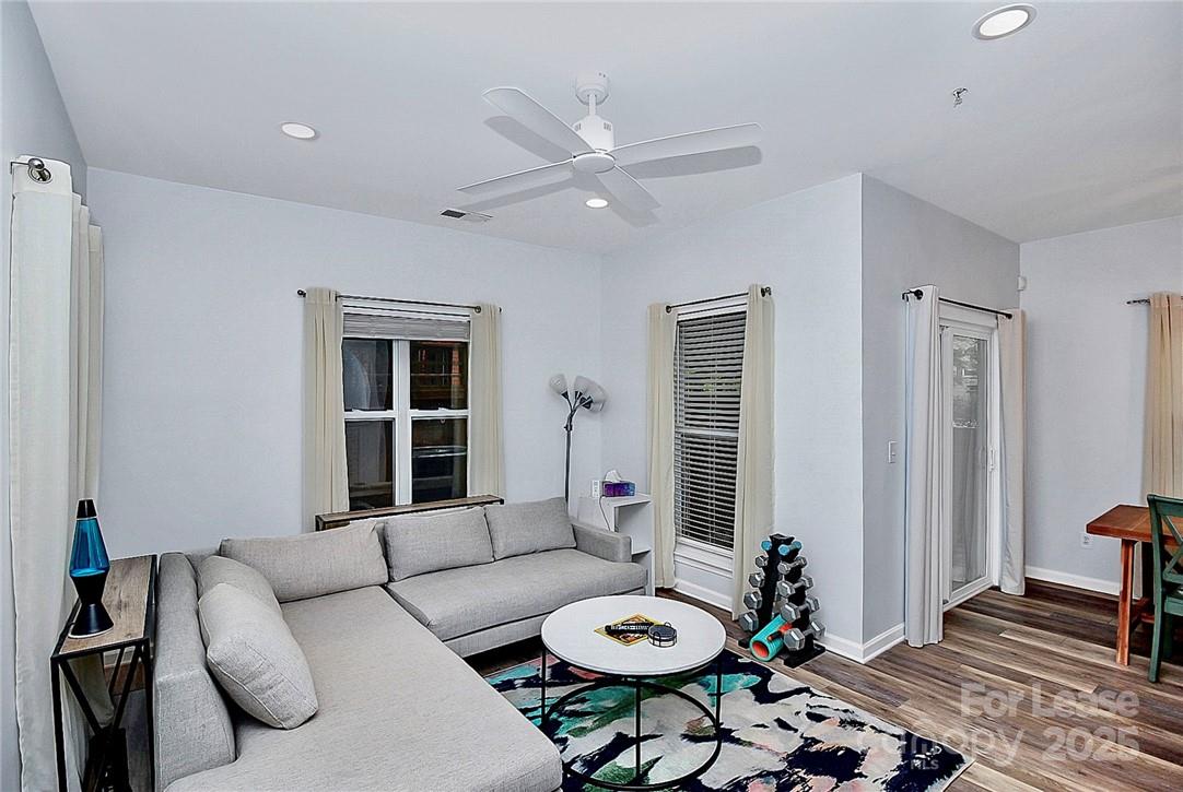 2625 East 5th Street, Unit A Charlotte, NC 28204 - Photo 17 of 24 a living room with furniture and wooden floor