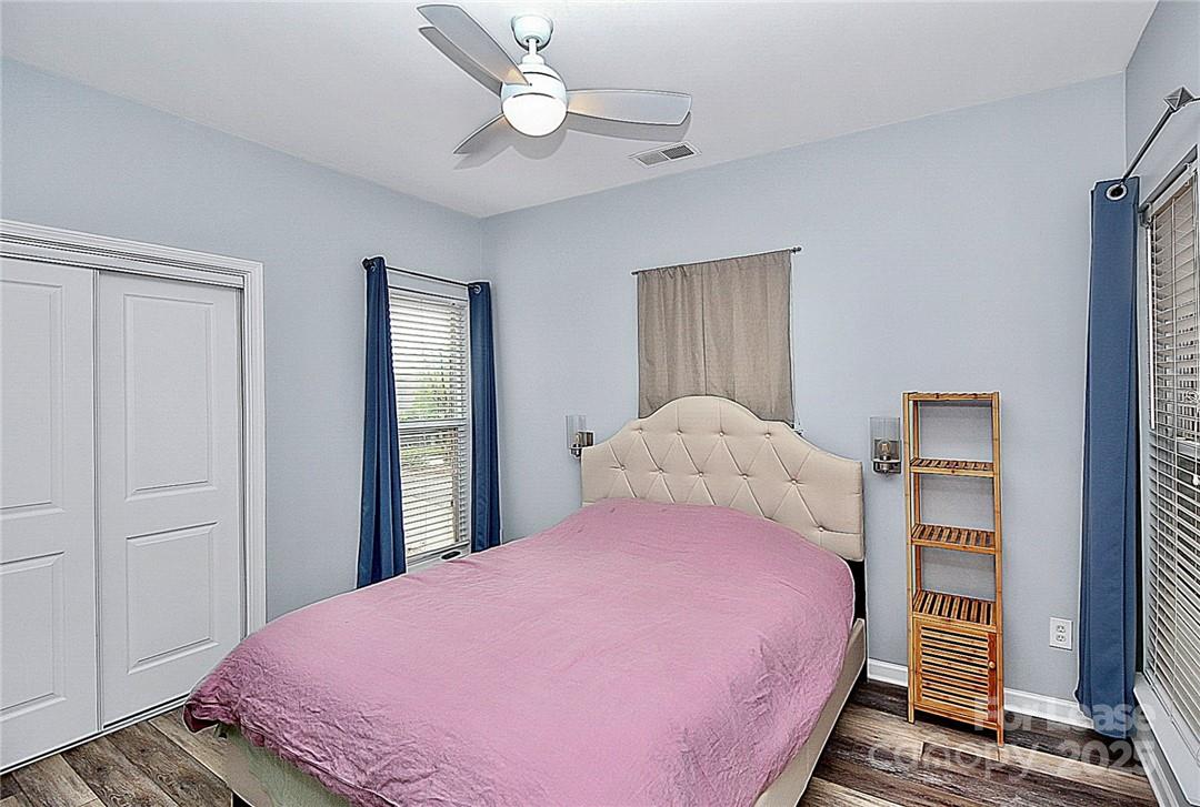 2625 East 5th Street, Unit A Charlotte, NC 28204 - Photo 20 of 24 a bedroom with a bed and a chandelier