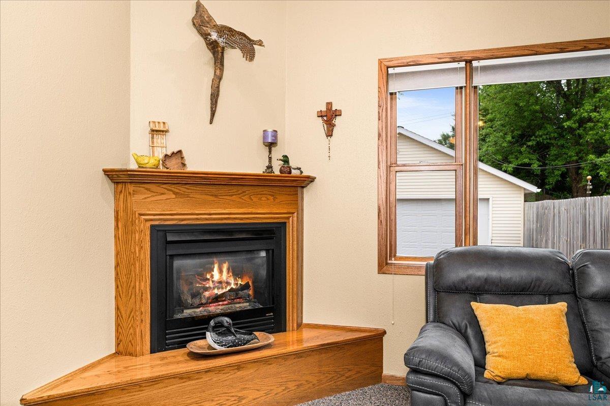 130 West Austin Street Duluth, MN 55803 - Photo 6 of 35 Corner fireplace featuring a wood mantel and hearth