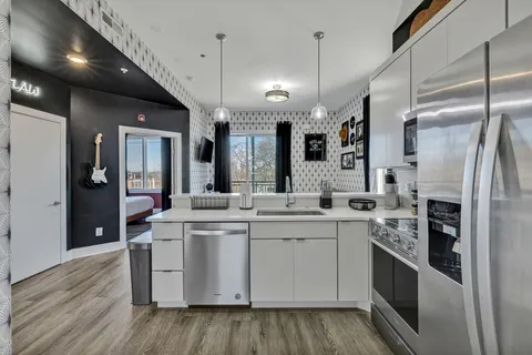 a kitchen with a sink stove and refrigerator