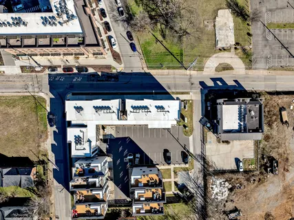 an aerial view of residential houses with outdoor space