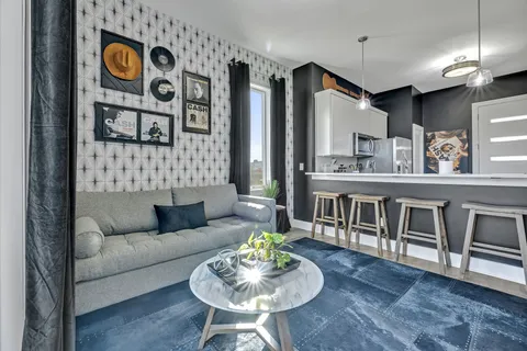 a living room with furniture and wooden floor