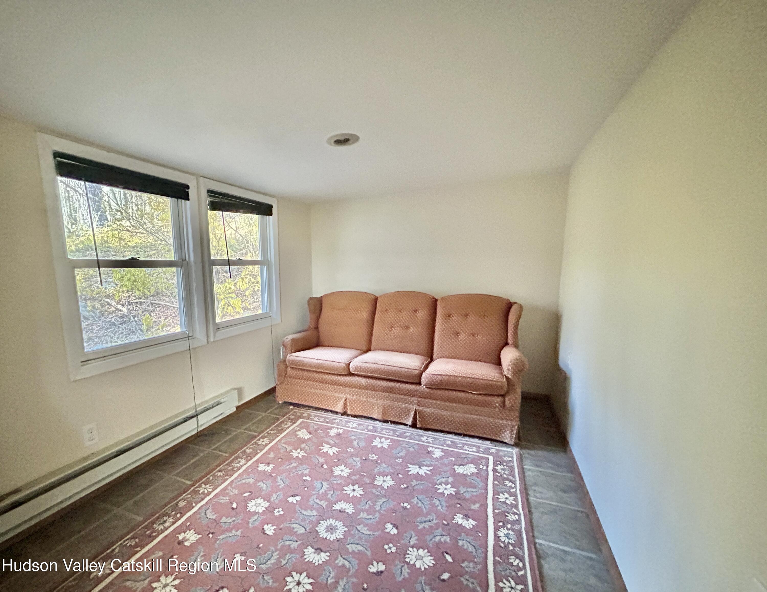 335 Tempaloni Road Ellenville, NY 12428 - Photo 12 of 26 a living room with furniture and a rug