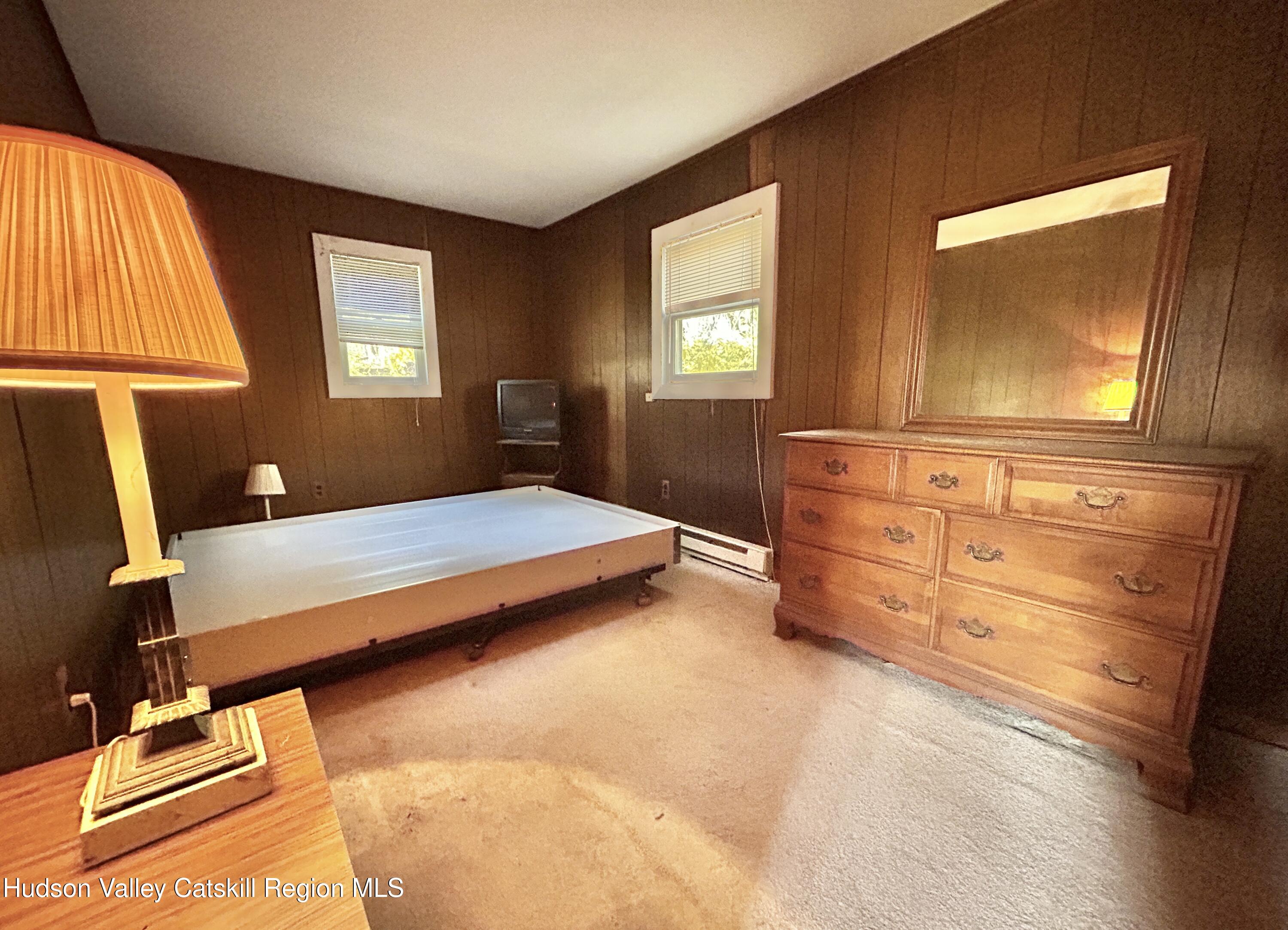 335 Tempaloni Road Ellenville, NY 12428 - Photo 14 of 26 a bedroom with a bed and a window