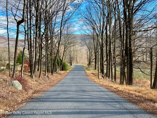a view of pathway with a wrought fence