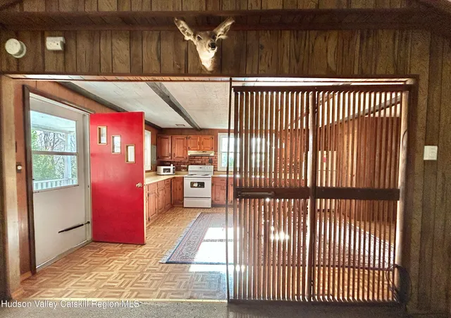 a view of a kitchen with a sink and wooden floor