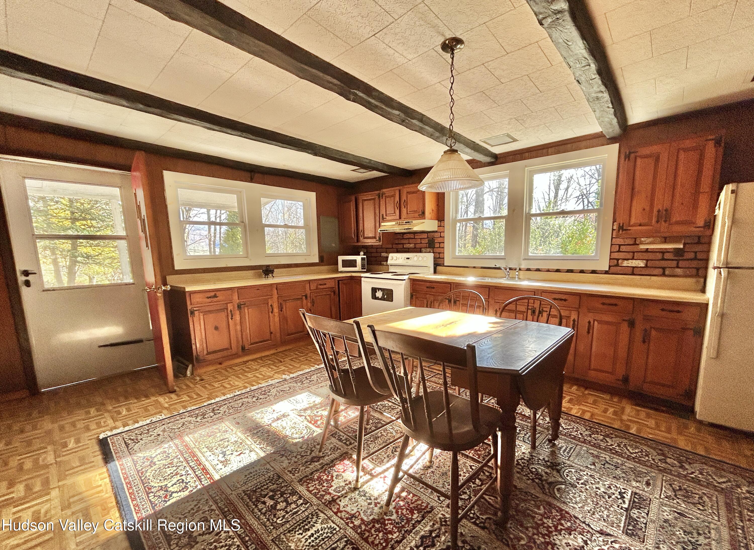 335 Tempaloni Road Ellenville, NY 12428 - Photo 7 of 26 a dining table with chairs and window