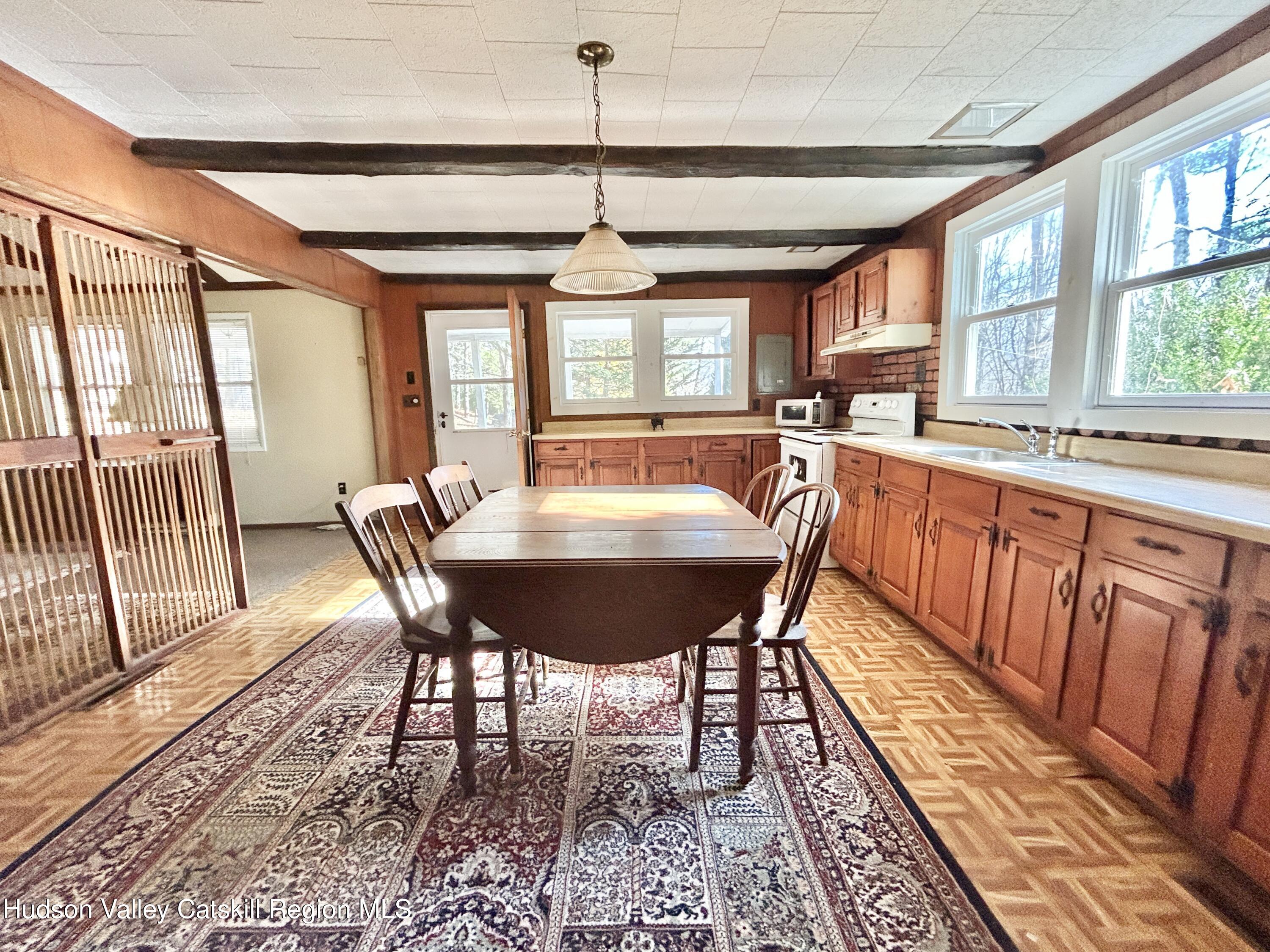 335 Tempaloni Road Ellenville, NY 12428 - Photo 8 of 26 a view of a dining room with furniture window and wooden floor