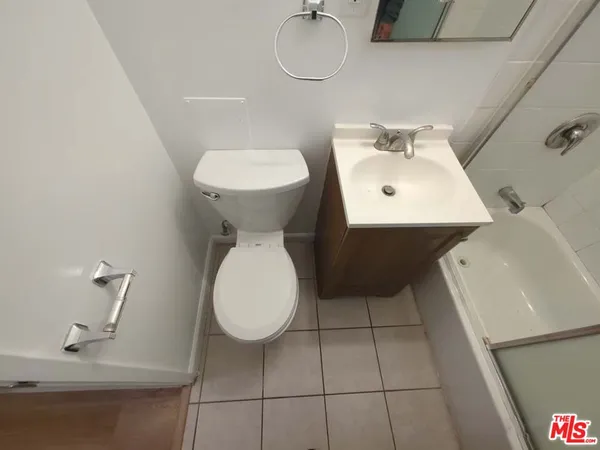 a bathroom with a sink toilet and mirror