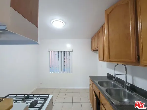 a kitchen that has a sink and a stove