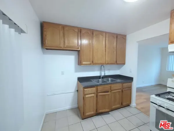 a kitchen with a sink cabinets and appliances