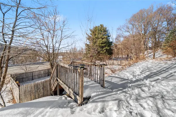 a view of house with a yard covered with snow in the background