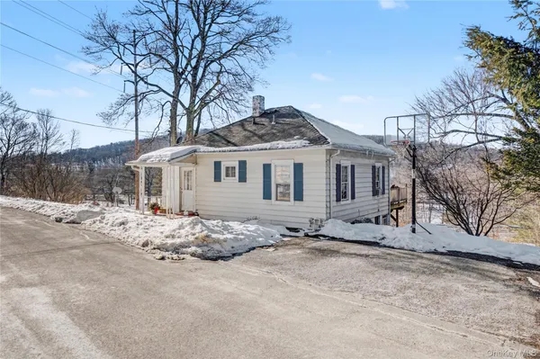 a big white house with a large tree in front of it