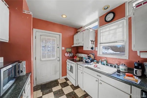 a kitchen that has a sink and a stove