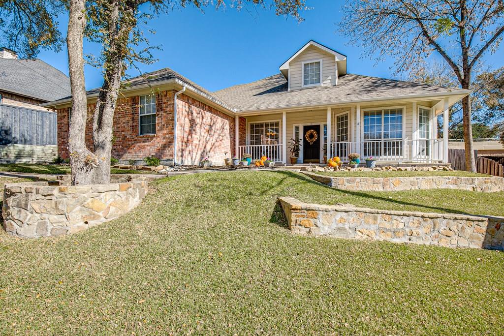 101 Independence Place Rockwall, TX 75032 - Photo 1 of 1 a front view of a house with a yard table and chairs