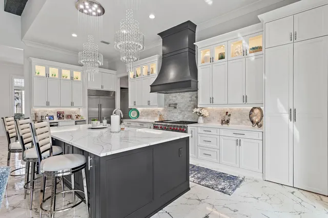 a kitchen with white cabinets appliances and a sink