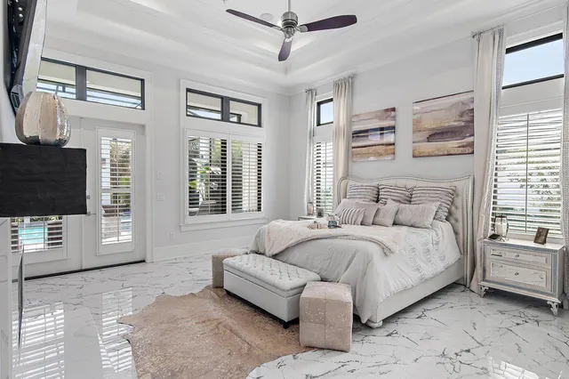 a bedroom with a bed couch and a flat tv screen