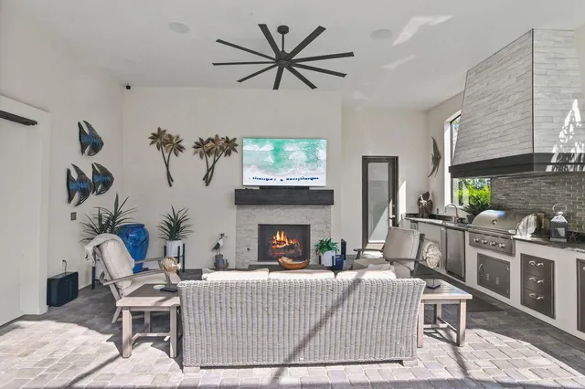a living room with furniture a fireplace and a flat screen tv