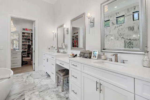 a spacious bathroom with a granite countertop sink mirror and a