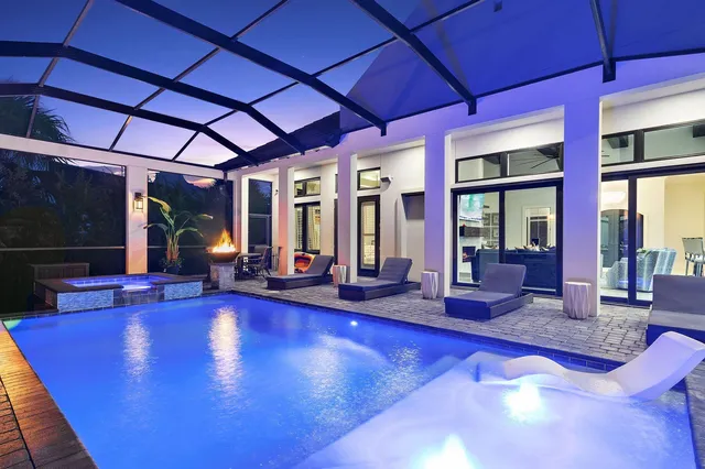 a swimming pool with outdoor seating