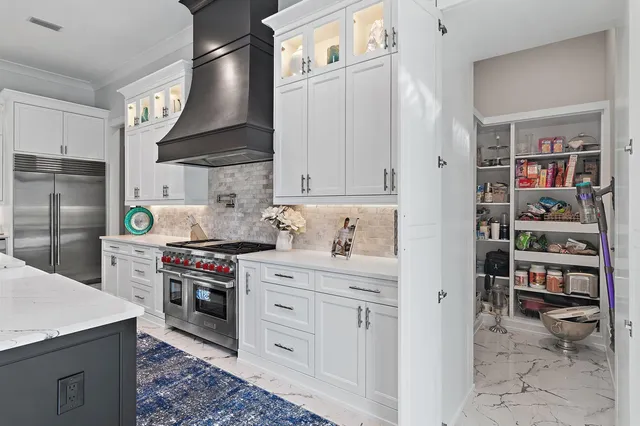 a kitchen with stainless steel appliances a stove a refrigerator and cabinets