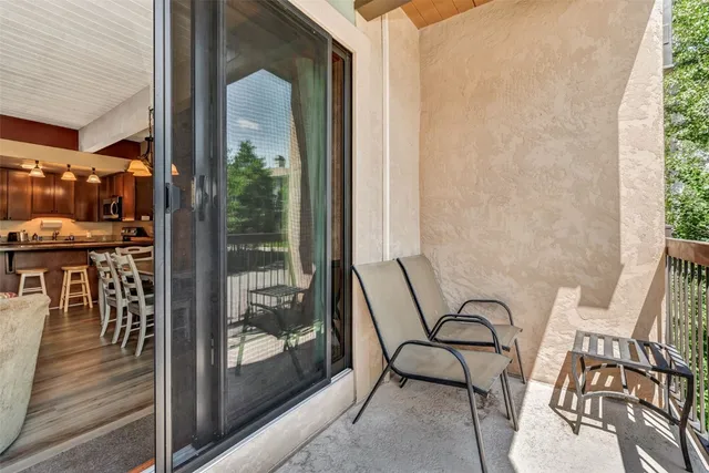 a balcony with table and chairs