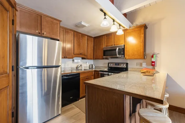 a kitchen with a refrigerator and a sink