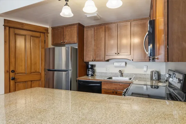 a kitchen with stainless steel appliances a refrigerator and a sink