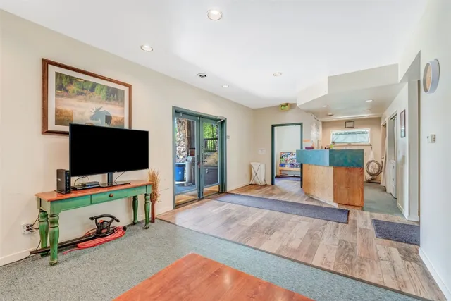 a living room with furniture and a wooden floor