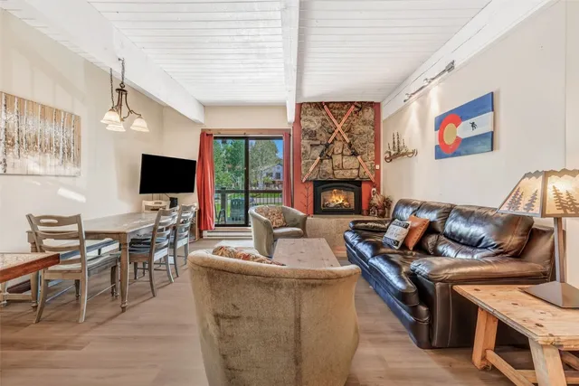 a living room with furniture flat screen tv and a fireplace