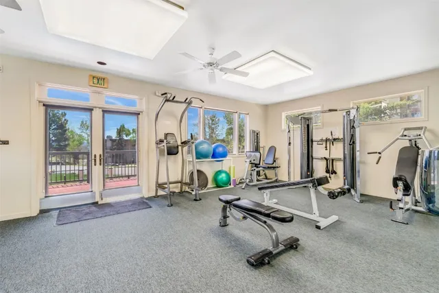 a room with gym equipment and mirror
